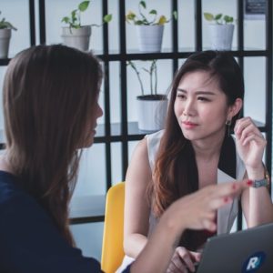 Woman listening intently to her colleague at work