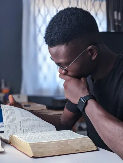 Man studying the book of Romans in the Bible