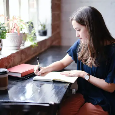 girl writing in a journal