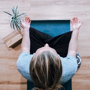 Woman Meditating on a Mat